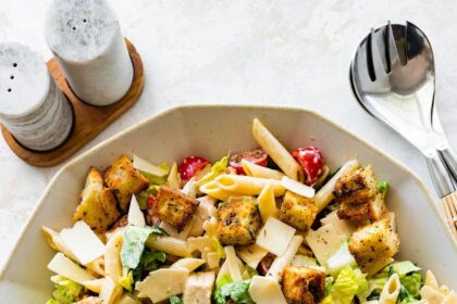 Chicken caesar pasta salad in a large bowl.