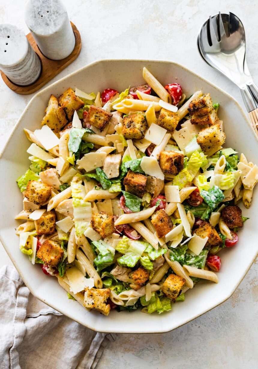 Chicken caesar pasta salad in a large bowl.