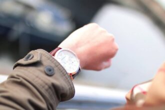 Man looking at watch to decide when to take metformin