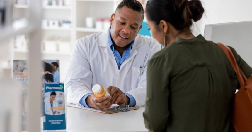 Image of a pharmacist explaining a medication to a customer