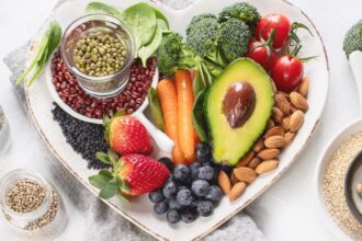 Heart-shaped dish containing various plant-based foods