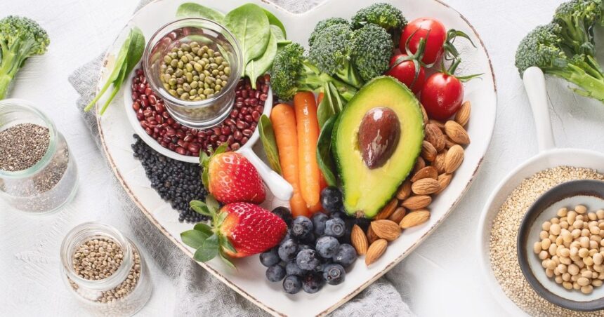 Heart-shaped dish containing various plant-based foods