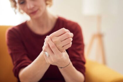 A woman holding her wrists