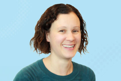 A smiling young female researcher, Dr Evelyn Parr, is shown against a blue background.