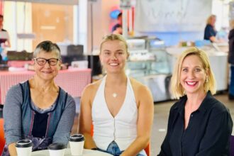 CDE Jane Giles, Molly Brooksby and Justine Cain sit at a table in Adelaide having coffees.