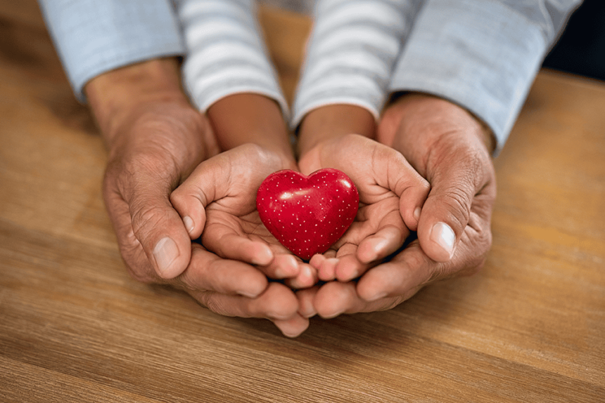 older hands, cupping child