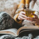 Woman drinking tea in bed.